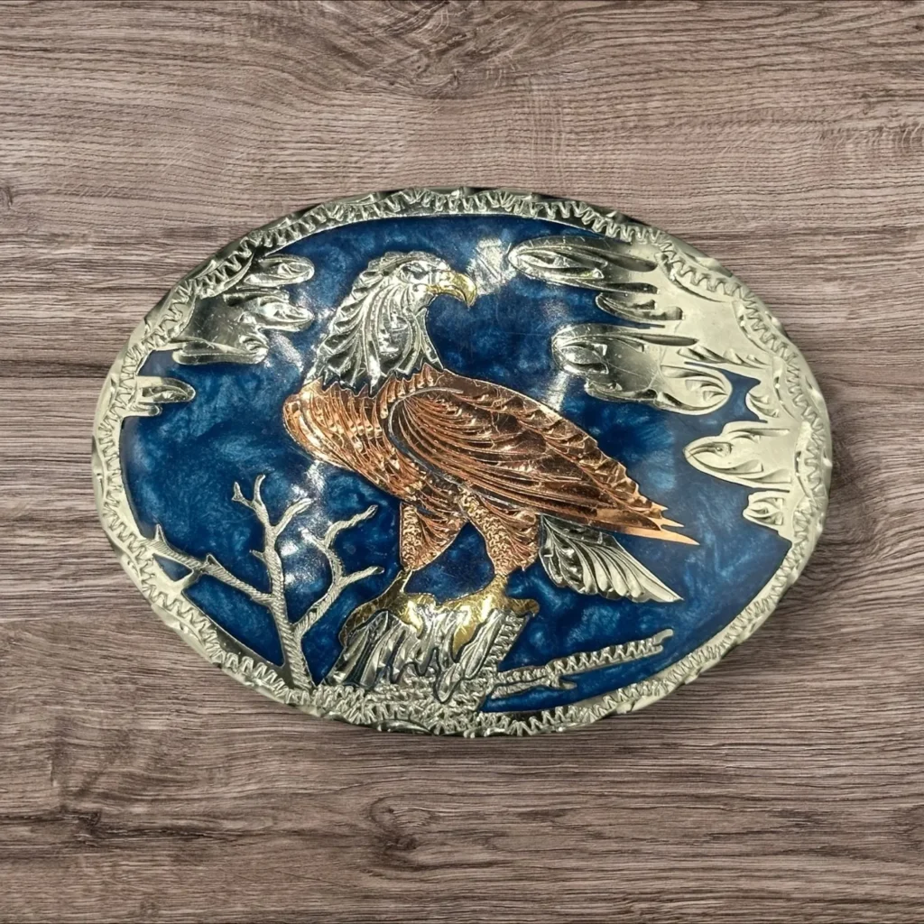 Silver Toned Belt Buckle with Bald Eagle perched on branch Blue Background (Front)